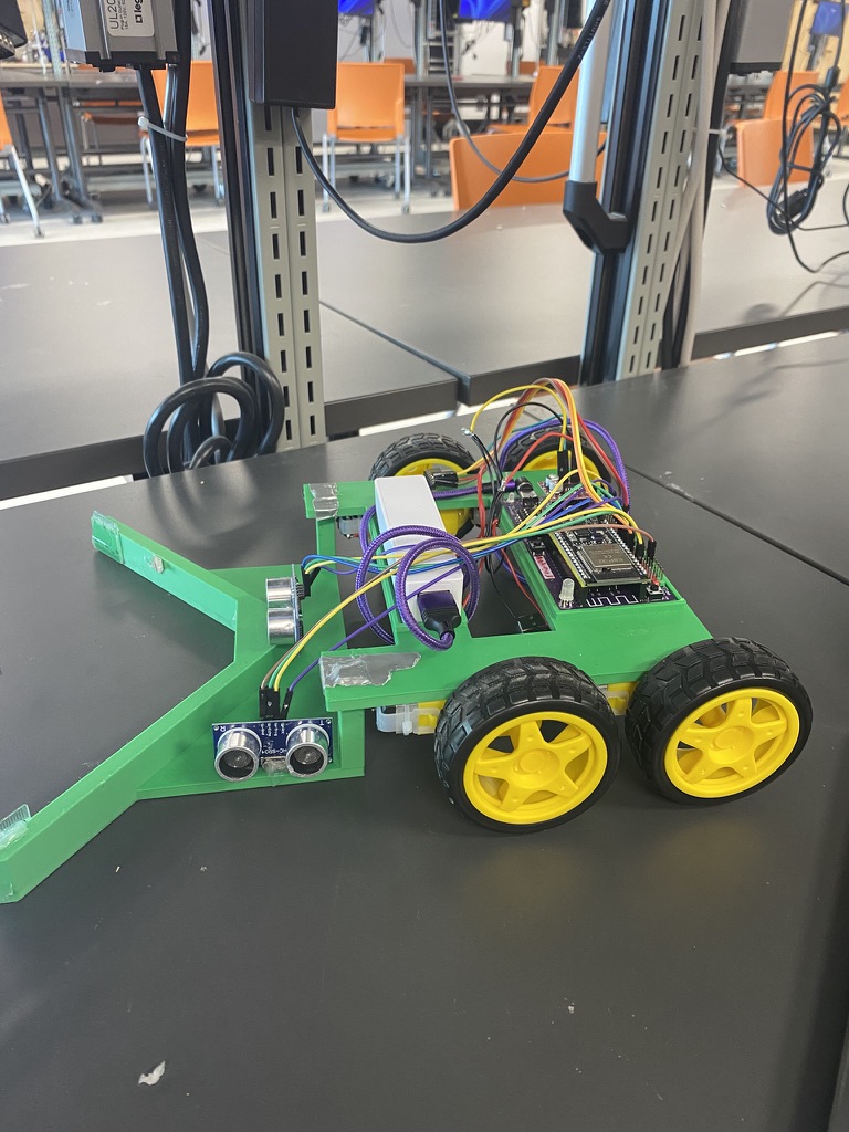 Close-up of the green autonomous eraser collector robot and its sensors